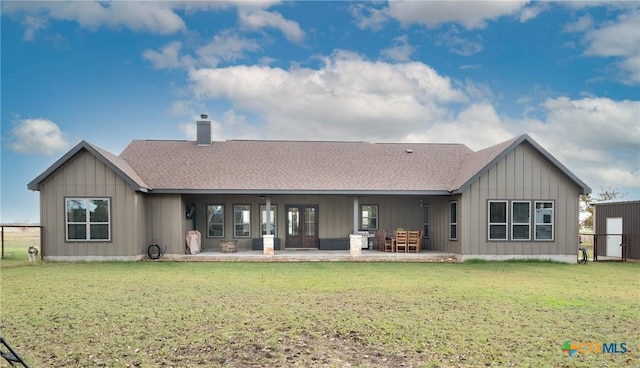 rear view of house with a patio area and a yard