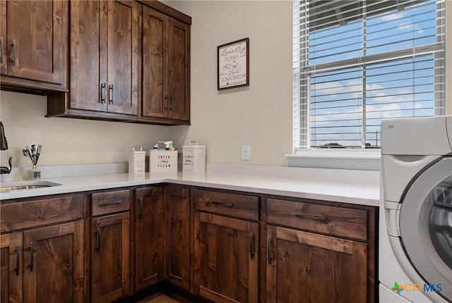 laundry area featuring cabinets, washer / clothes dryer, plenty of natural light, and sink