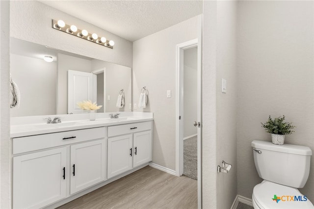 419 Agave Flats Dr, New Braunfels, TX 78130 - full bathroom with double vanity, wood finished floors, and a textured ceiling