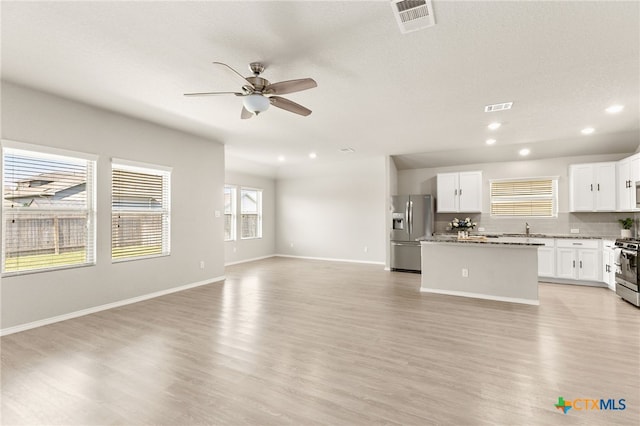 419 Agave Flats Dr, New Braunfels, TX 78130 - unfurnished living room with a ceiling fan, light wood-type flooring, and recessed lighting