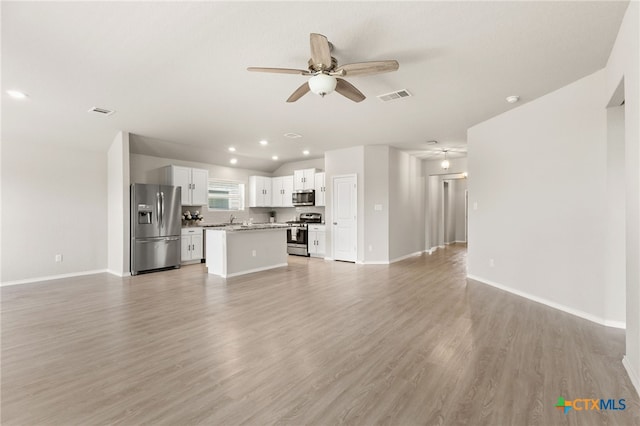 419 Agave Flats Dr, New Braunfels, TX 78130 - unfurnished living room featuring a ceiling fan, light wood-style floors, and recessed lighting