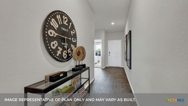 corridor featuring dark wood-style floors, a textured wall, and baseboards