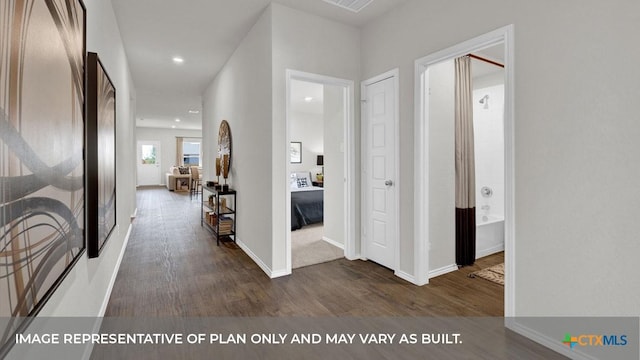 corridor featuring recessed lighting, baseboards, and wood finished floors