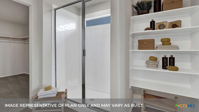 full bathroom featuring a shower stall and a spacious closet