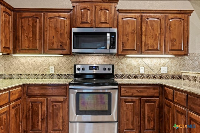 1722 Shadow Canyon Dr, Temple, TX 76502 - kitchen with appliances with stainless steel finishes, light stone counters, and tasteful backsplash