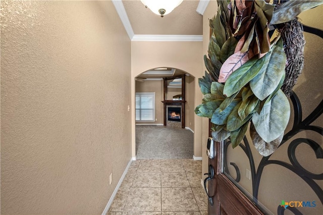 1722 Shadow Canyon Dr, Temple, TX 76502 - hallway featuring arched walkways, ornamental molding, a textured wall, tile patterned flooring, and carpet