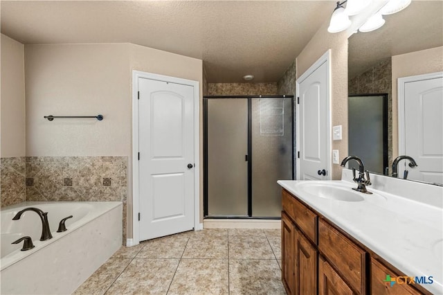 1722 Shadow Canyon Dr, Temple, TX 76502 - bathroom featuring vanity, a stall shower, tile patterned floors, a garden tub, and a textured ceiling