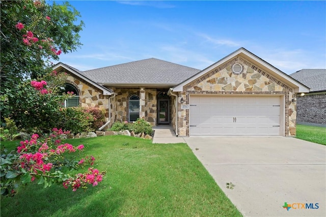 1722 Shadow Canyon Dr, Temple, TX 76502 - view of front of property featuring stone siding, an attached garage, concrete driveway, and a front yard