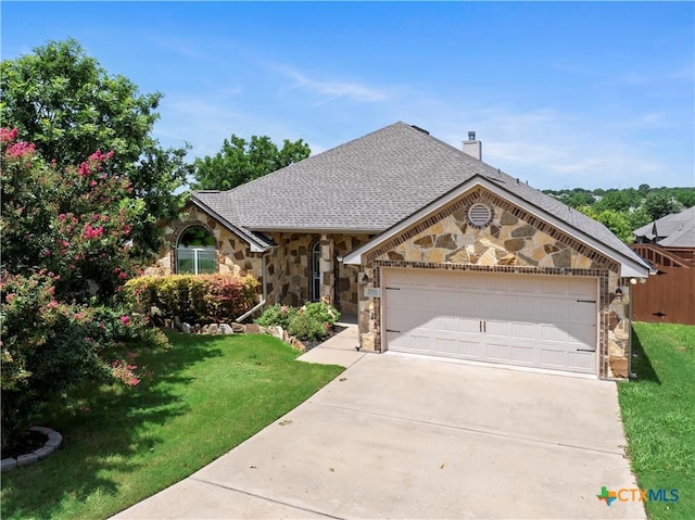 1722 Shadow Canyon Dr, Temple, TX 76502 - view of front of house featuring stone siding, driveway, a garage, and a front lawn