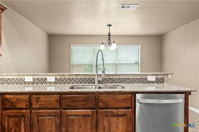 1722 Shadow Canyon Dr, Temple, TX 76502 - kitchen featuring stainless steel dishwasher, healthy amount of natural light, light stone counters, hanging light fixtures, and a textured ceiling