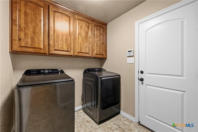 1722 Shadow Canyon Dr, Temple, TX 76502 - washroom featuring washer and dryer, cabinet space, light tile patterned flooring, and a textured ceiling
