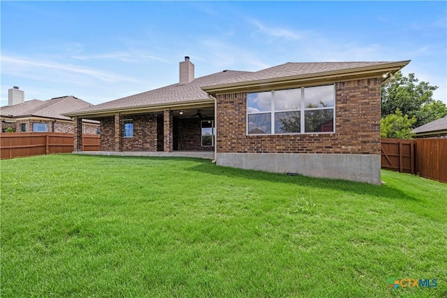 1722 Shadow Canyon Dr, Temple, TX 76502 - rear view of property with a fenced backyard, brick siding, a chimney, a ceiling fan, and a shingled roof