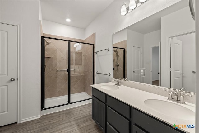 bathroom featuring vanity and a shower with shower door