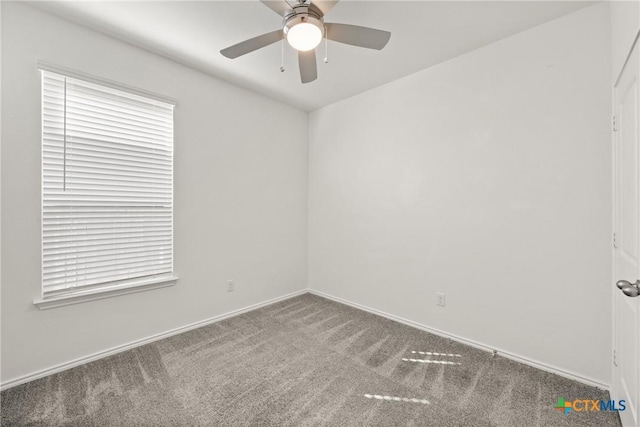 empty room featuring carpet floors and ceiling fan