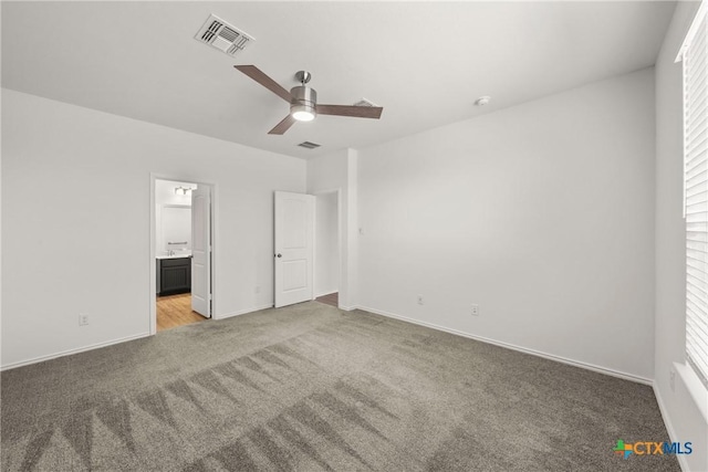 unfurnished bedroom with connected bathroom, light colored carpet, and ceiling fan