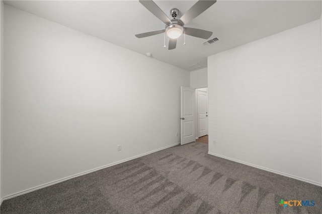 carpeted spare room featuring ceiling fan