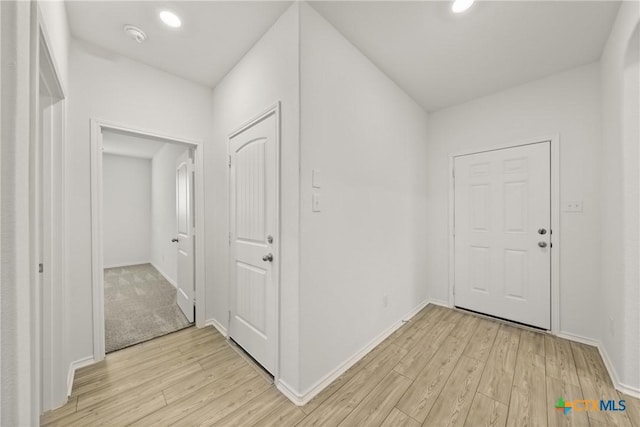 corridor with light hardwood / wood-style flooring