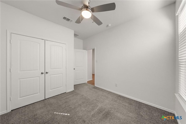 unfurnished bedroom featuring carpet flooring, ceiling fan, and a closet