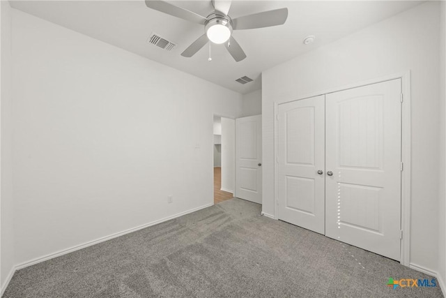 unfurnished bedroom with carpet flooring, ceiling fan, and a closet