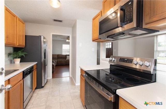 kitchen with light countertops, visible vents, appliances with stainless steel finishes, and light tile patterned flooring