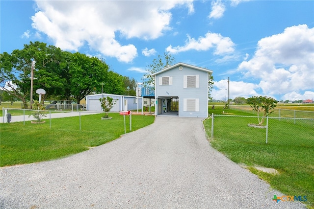 view of front of house featuring basketball hoop, a garage, a front yard, and an outdoor structure