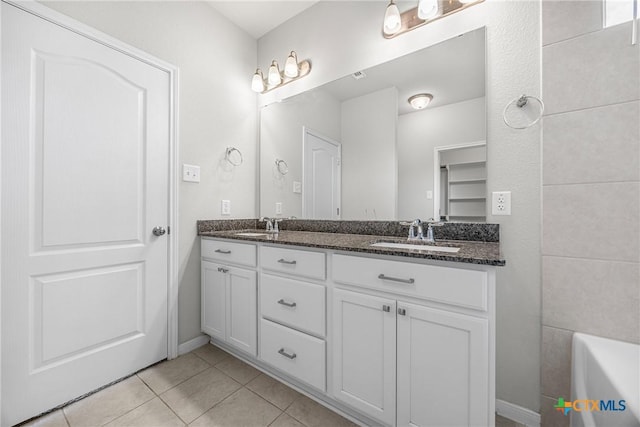 1041 Lakeway Crossing Dr, Temple, TX 76502 - full bath with double vanity, tile patterned floors, a bathtub, and baseboards