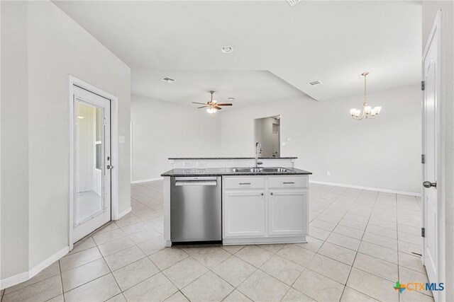 1041 Lakeway Crossing Dr, Temple, TX 76502 - kitchen featuring stainless steel dishwasher, dark countertops, a sink, white cabinetry, and light tile patterned flooring