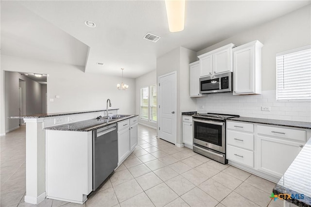 1041 Lakeway Crossing Dr, Temple, TX 76502 - kitchen featuring stainless steel appliances, a chandelier, light tile patterned flooring, and backsplash