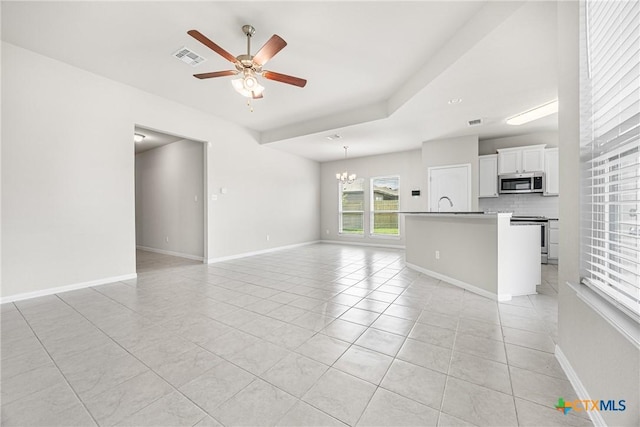 1041 Lakeway Crossing Dr, Temple, TX 76502 - unfurnished living room with light tile patterned floors, ceiling fan, a chandelier, and baseboards