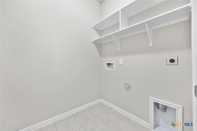 1041 Lakeway Crossing Dr, Temple, TX 76502 - laundry area with hookup for a gas dryer, hookup for a washing machine, electric dryer hookup, baseboards, and light tile patterned floors