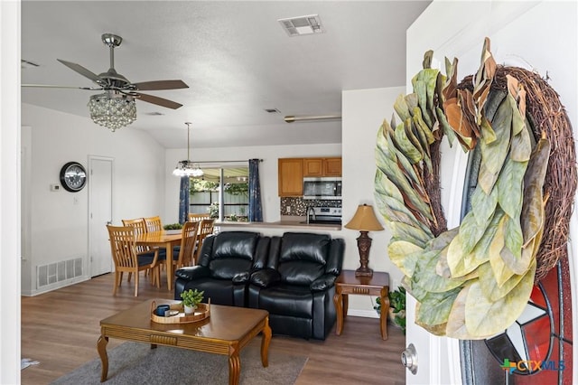 605 Aikman Dr, Troy, TX 76579 - living room featuring ceiling fan, wood finished floors, lofted ceiling, and a chandelier