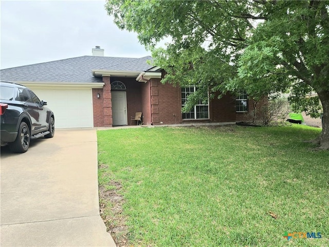 3909 Hopi Trl, Temple, TX 76504 - ranch-style house with a garage, a front lawn, driveway, brick siding, and a chimney
