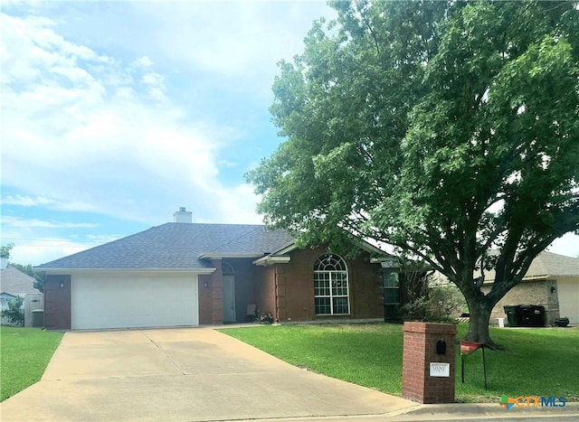 3909 Hopi Trl, Temple, TX 76504 - single story home featuring driveway, a front lawn, an attached garage, a chimney, and a shingled roof