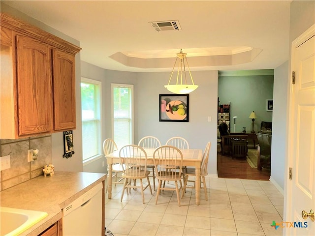 3909 Hopi Trl, Temple, TX 76504 - dining space with a tray ceiling and light tile patterned flooring
