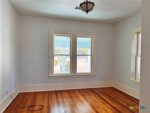 empty room with hardwood / wood-style floors