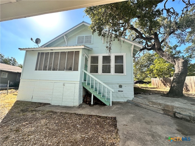 view of front of house featuring a sunroom