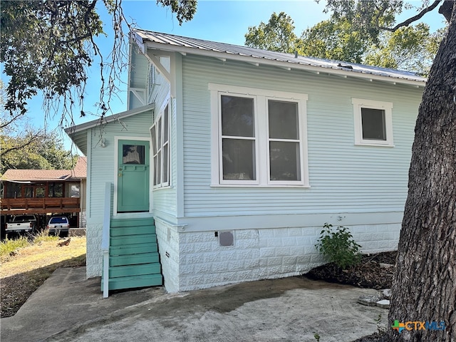 view of side of home with a patio area