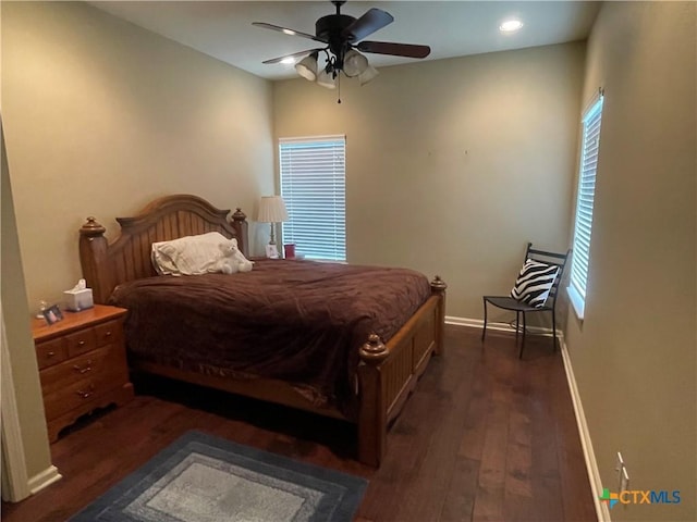 bedroom with baseboards, a ceiling fan, and dark wood-style floors