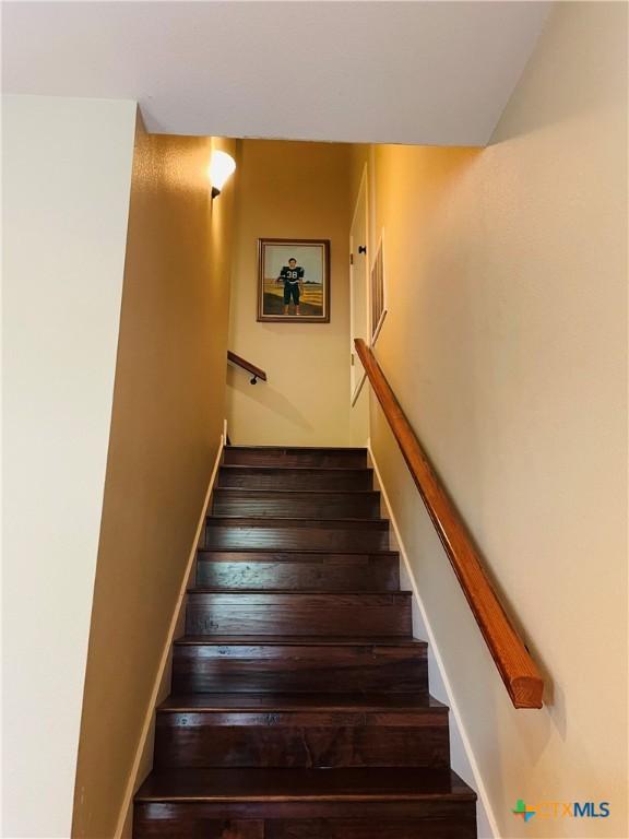 staircase with hardwood / wood-style flooring