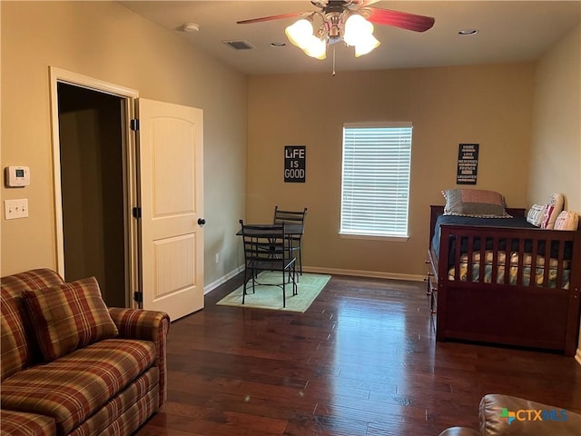 bedroom with visible vents, baseboards, wood finished floors, and ceiling fan