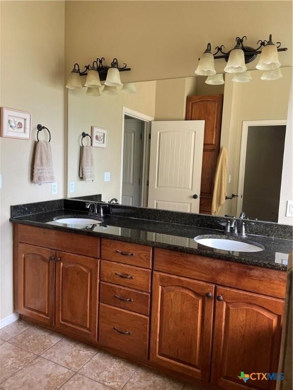 bathroom with tile patterned flooring, a sink, and double vanity