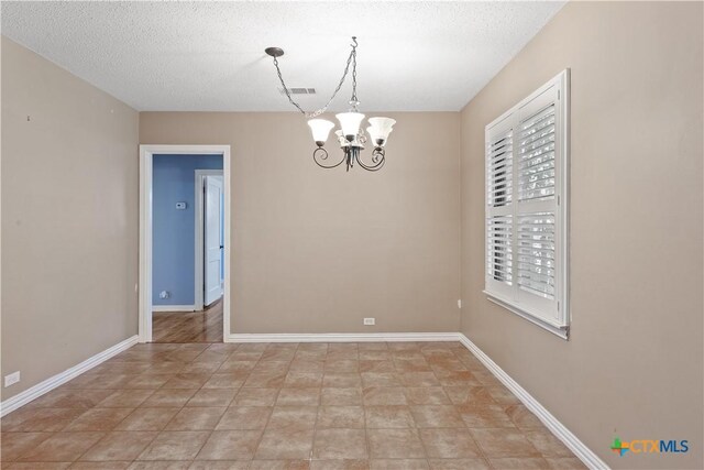 1404 N Beal St, Belton, TX 76513 - empty room featuring a chandelier, baseboards, and a textured ceiling