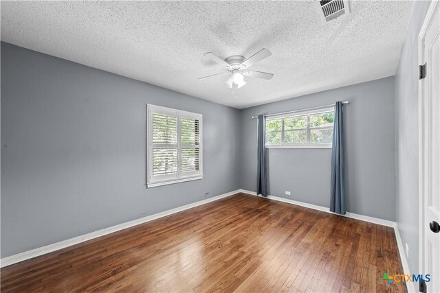 1404 N Beal St, Belton, TX 76513 - unfurnished room with ceiling fan, a textured ceiling, hardwood / wood-style floors, and baseboards