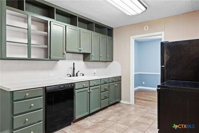 1404 N Beal St, Belton, TX 76513 - kitchen featuring green cabinets, black appliances, a sink, open shelves, and a textured ceiling