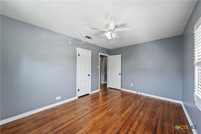 1404 N Beal St, Belton, TX 76513 - unfurnished bedroom with baseboards, wood finished floors, and a ceiling fan