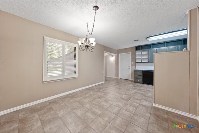 1404 N Beal St, Belton, TX 76513 - unfurnished dining area featuring a textured ceiling, a chandelier, and baseboards
