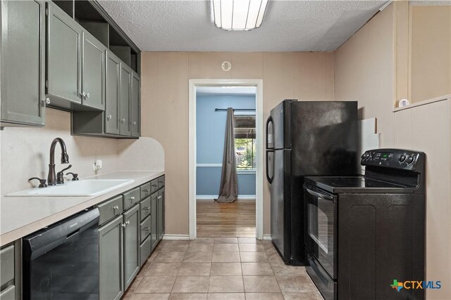 1404 N Beal St, Belton, TX 76513 - kitchen featuring black appliances, a sink, light countertops, a textured ceiling, and light tile patterned floors