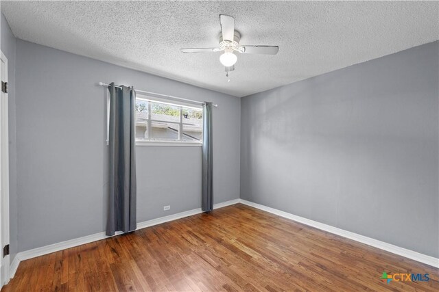 1404 N Beal St, Belton, TX 76513 - empty room featuring wood finished floors, ceiling fan, a textured ceiling, and baseboards