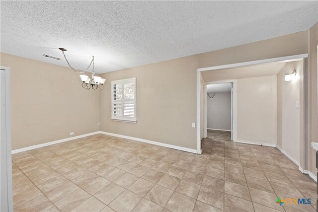 1404 N Beal St, Belton, TX 76513 - empty room featuring a chandelier, a textured ceiling, baseboards, and light tile patterned floors