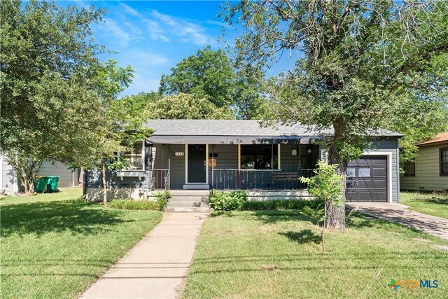 1404 N Beal St, Belton, TX 76513 - ranch-style home featuring a garage, a porch, a front lawn, and driveway